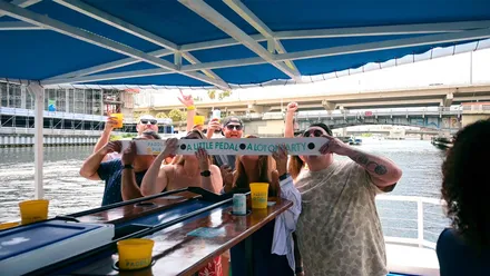 A party boat heading down the Tampa Riverwalk